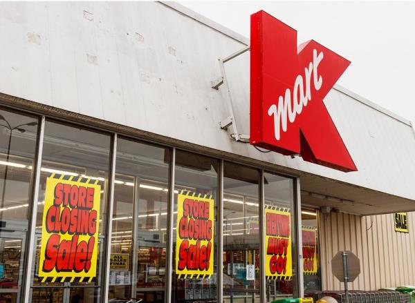'Store Closing' signs in the window of a Kmart store